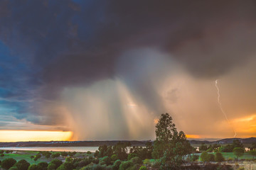A storm rain breaks over Ayamonte, Andalucia Spain and the Guadiana river at dusk.