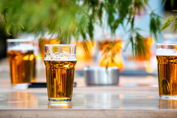 Glasses with beer on the coffee table.