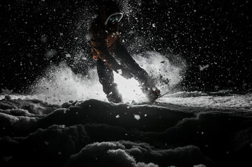 Obraz premium Active snowboarder in sportswear jumping on the board at night