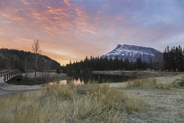 Dramatic Sunrise Sky over Cascade Pond and Distant Rundle Mountain Landscape in Banff National Park, Rocky Mountains, Alberta, Canada