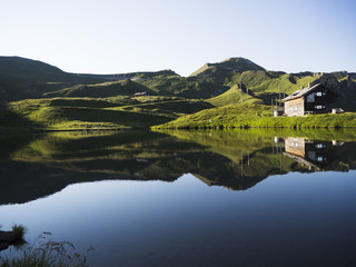 Reflection of chalet and mountain in the lake