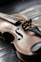 A part of a violin or a viola on a wood background