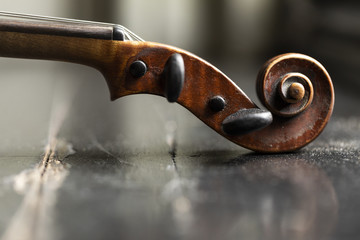 A part of a violin or a viola on a wood background