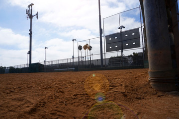 empty baseball field with bright sun flare