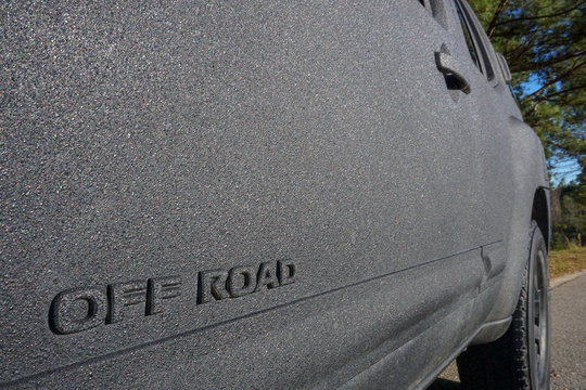 OFF ROAD logo on SUV with textured bed liner coating