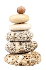 Fototapeta na wymiar Pyramid of pebbles isolated on white. Stones on the table. Wellness concept. Sea stones.