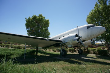 Fototapeta na wymiar A cargo plane placed on a display stand on a grassy land