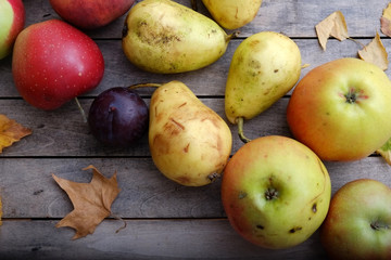Various colorful fruits on autumn wooden table