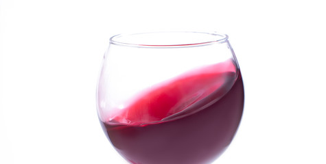 A glass with red wine on a white background. Isolate
