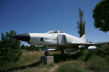 A fighter plane placed on a display stand on a grassy land