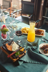 Steak from salmon with sauce and a decanter of a berry drink