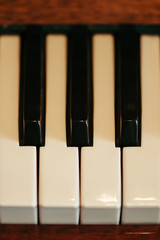 Naklejka premium Old Piano keys in artistic processing. Musical instrument. View from above.