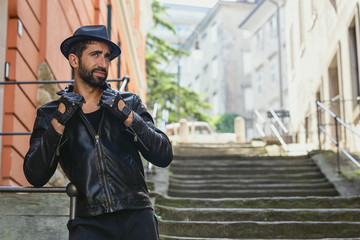 A stylish man with a beard in a black jacket