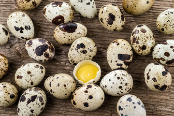Quail eggs on a wood background. Yolk quail eggs without shell. Selective focus.