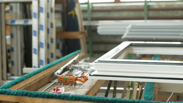 Production and manufacturing of plastic windows pvc, on the table lies the sash window, screwdriver, the shop is finished products windows