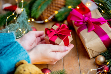 hands holding a gift box on Christmas background