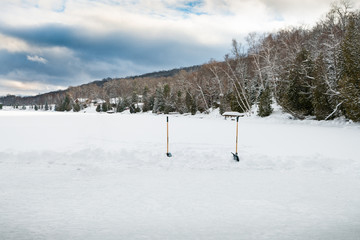 Winter landscape, mid afternoon, dramatic winter clouds,snow covered frozen lake. with a section...