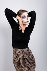 girl in a black sweater on a white background with Halloween makeup