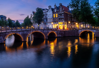 Fototapeta na wymiar Bridge over Keizersgracht - Emperor's canal in Amsterdam, The Netherlands at twilight.