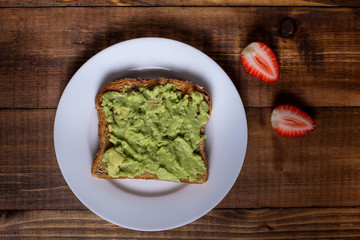 Toast with avocado spread and strawberry