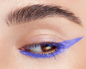 Beautiful macro shot of female eye with extreme long eyelashes and black liner makeup. Perfect...