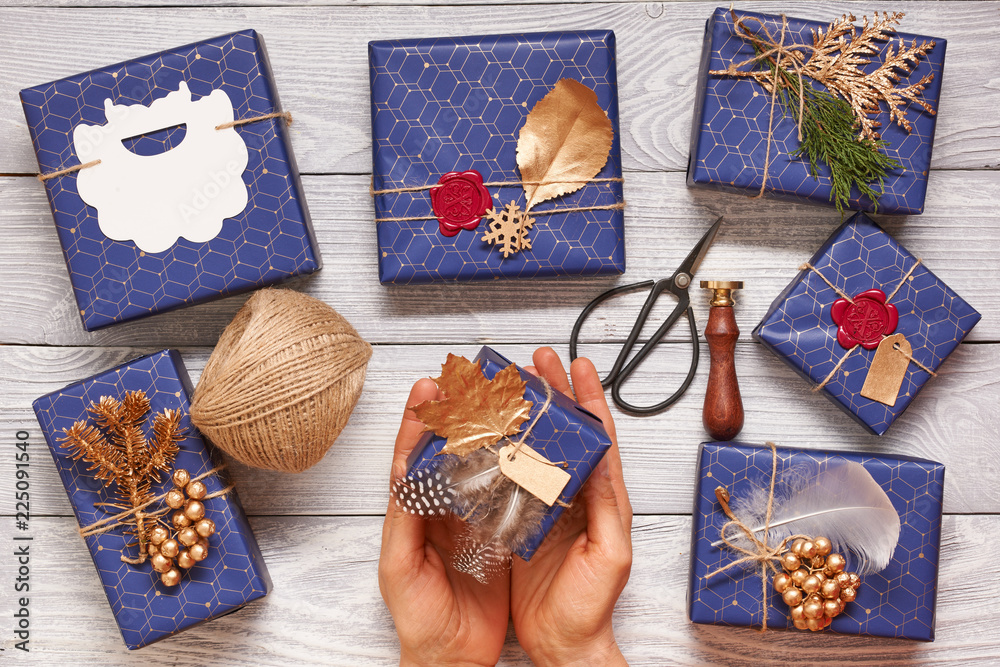 Sticker woman wrapping christmas presents over wooden background