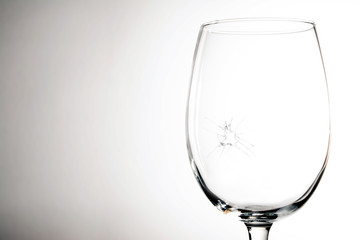 Broken wine glass on a grey background