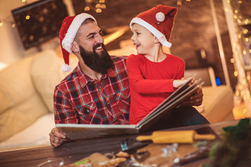 Father and son reading book for Christmas eve