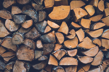 Stack of firewood. Abstract wood log background close-up.
