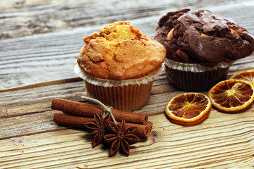 Chocolate muffin and nut muffin, homemade bakery on wooden background.
