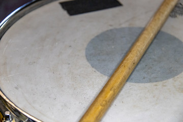 drumstick on old marching snare