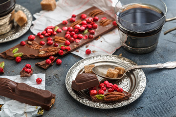 Cups of coffee with chocolate on a stone background.