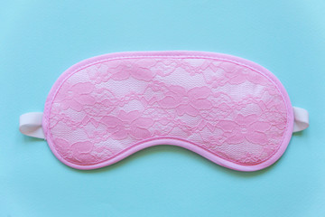 Sleeping eye mask, isolated on blue pastel colourful trendy background. Do not disturb me, let me sleep. Rest, good night, insomnia, relaxation, tired, travel concept