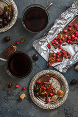 Cups of coffee with chocolate on a stone background.