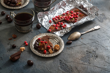 Cups of coffee with chocolate on a stone background.