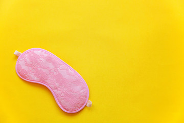 Sleeping eye mask, isolated on yellow colourful trendy background. Do not disturb me, let me sleep. Rest, good night, insomnia, relaxation, tired, travel concept