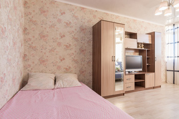 Interior of the hotel room, bed, wardrobes, TV