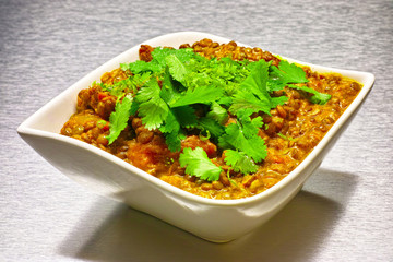 Moong Dahl, indian vegetarian lentil soup in white bowl.