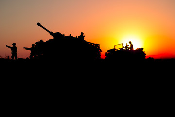 Fototapeta na wymiar War Concept. Military silhouettes fighting scene. World War German Tanks and soldiers silhouettes at sunset. Attack scene. Armored vehicles.
