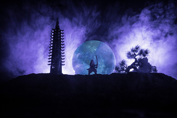 Samurai fighting concept. Silhouette of samurais in duel near tree and old temple. Picture with two...