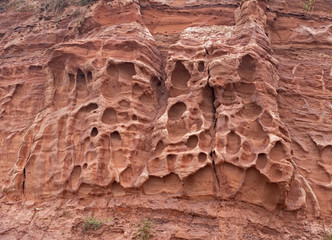 Erosion in the red sandstone coastal cliffs at Budleigh Salterton, Devon, UK. Geology on the Jurassic coast.