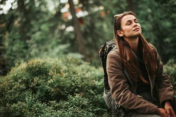 Fotobehang Slaapkamer I feel healing energy. Portrait of serene girl with closed eyes enjoying atmosphere of coniferous wood  © Yakobchuk Olena