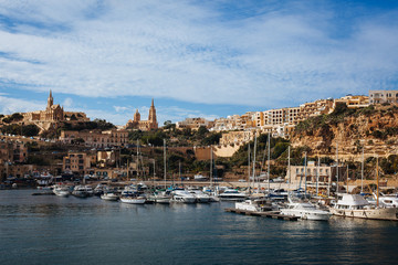 Fototapeta na wymiar Panoramic Bay View of Mgarr, Town and harbor where Ferries Dock at the East End of Island Gozo, Malta