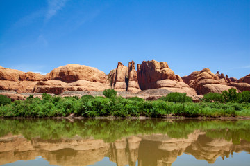 Water view from the Colorado River along the bluffs and rock sculpture outside Moab, Utah