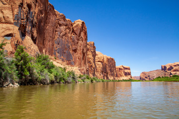 Water view from the Colorado River along the bluffs and rock sculpture outside Moab, Utah