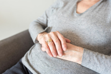 Close up cropped view of older woman's hands (selective focus)