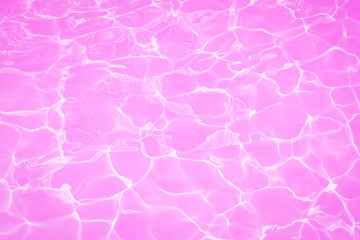 Surface of beautiful pink water in swimming pool texture background