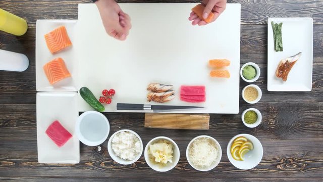 Sushi ingredients on a table. Hands of chef, japanese food.