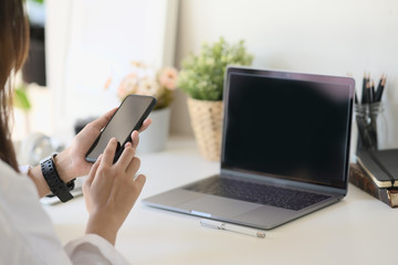 Unrecognizable businesswoman using a mobile phone on desk