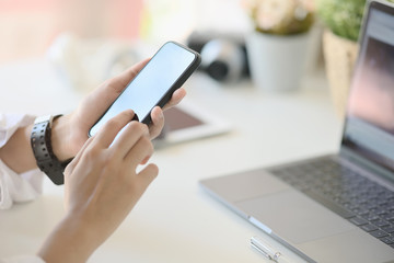 Unrecognizable businesswoman using a mobile phone on desk